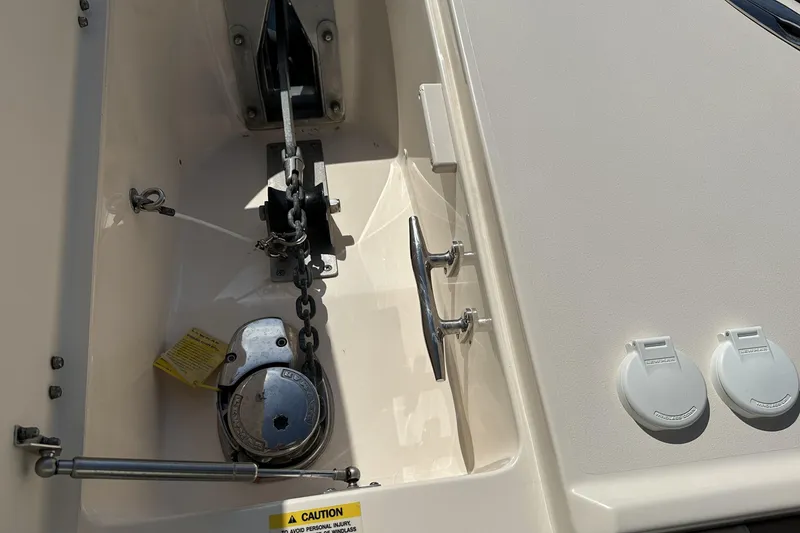 Slide: The Image of Anchor compartment of 2013 Grady-White Freedom 285 boat with chain and cleat. - 22