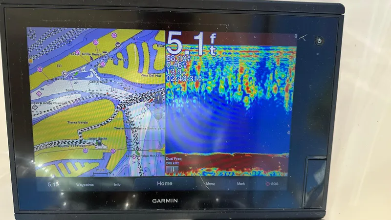 Slide: The Image of Garmin marine GPS display showing navigation map and sonar depth reading on Grady-White Freedom 285. - 26