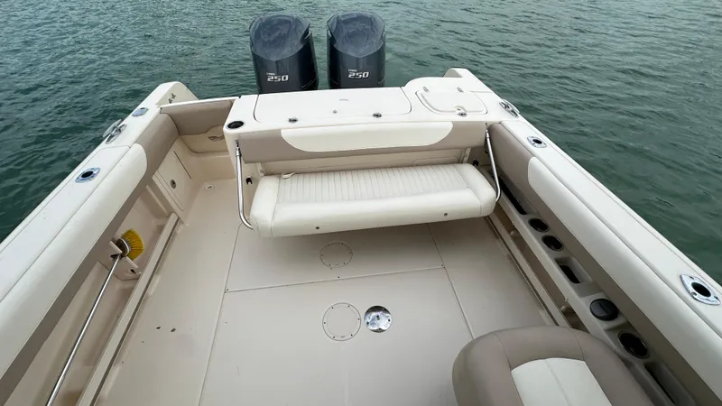 Slide: The Image of 2013 Grady-White Freedom 285 boat interior with dual engines on water. - 28