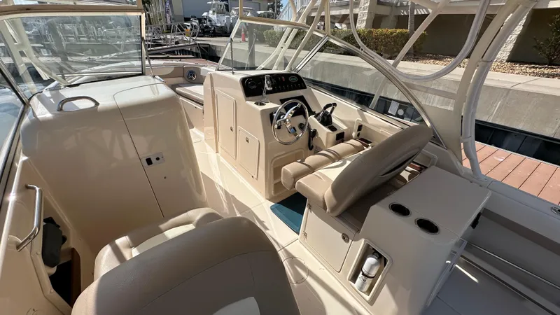 Slide: The Image of 2013 Grady-White Freedom 285 boat interior with helm, seating, and controls. - 9