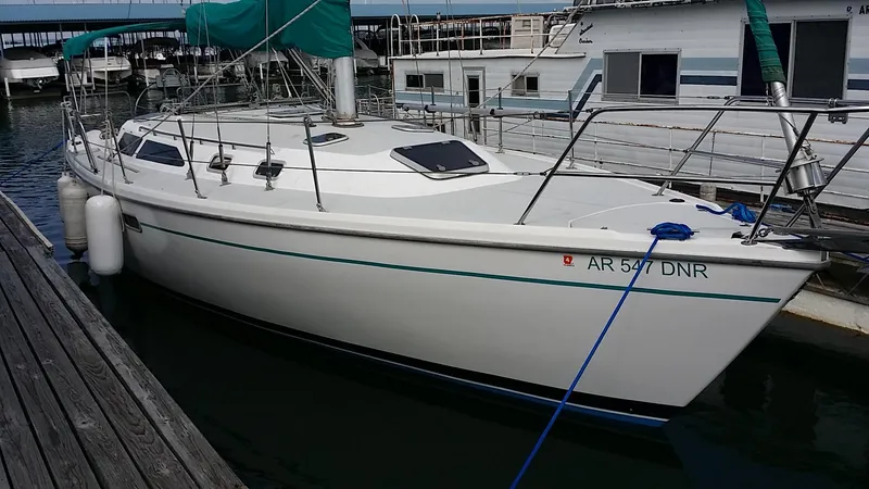 The Image of 1996 Catalina 36 MK 2 sailboat docked at marina, featuring sleek white hull and green sail cover. - 0