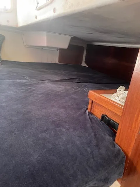 Slide: The Image of Interior cabin of 1996 Catalina 36 MK 2 sailboat with dark bedding. - 11