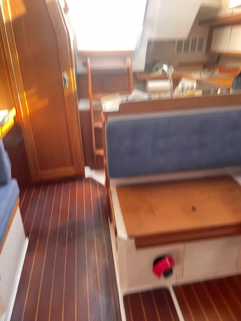 Slide: The Image of Interior of 1996 Catalina 36 MK 2 sailboat with wooden flooring and blue seating. - 8