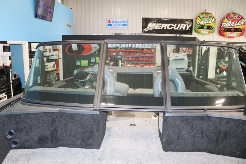 Slide: The Image of 2025 Alumacraft Competitor 175X Sport Rotax S boat interior with windshield and seating. - 10