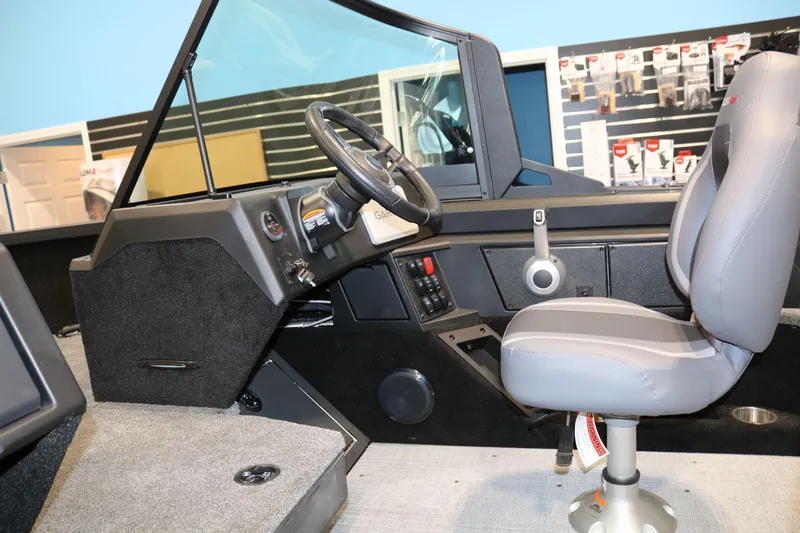 Slide: The Image of Interior of 2025 Alumacraft Competitor 175X Sport Rotax S boat, featuring steering and seating area. - 13