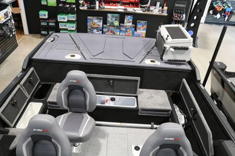 Slide: The Image of 2025 Alumacraft Competitor 175X Sport Rotax S interior with seating and storage compartments. - 19