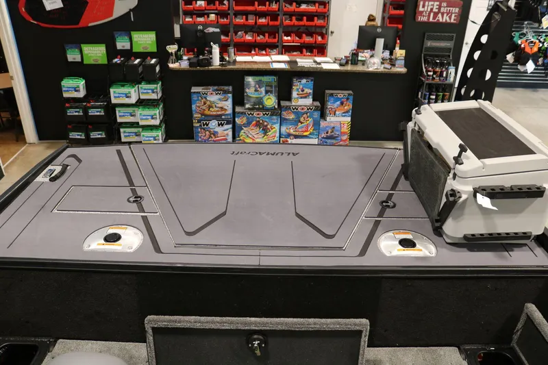 Slide: The Image of 2025 Alumacraft Competitor 175X Sport Rotax S boat deck with storage and cooler. - 20