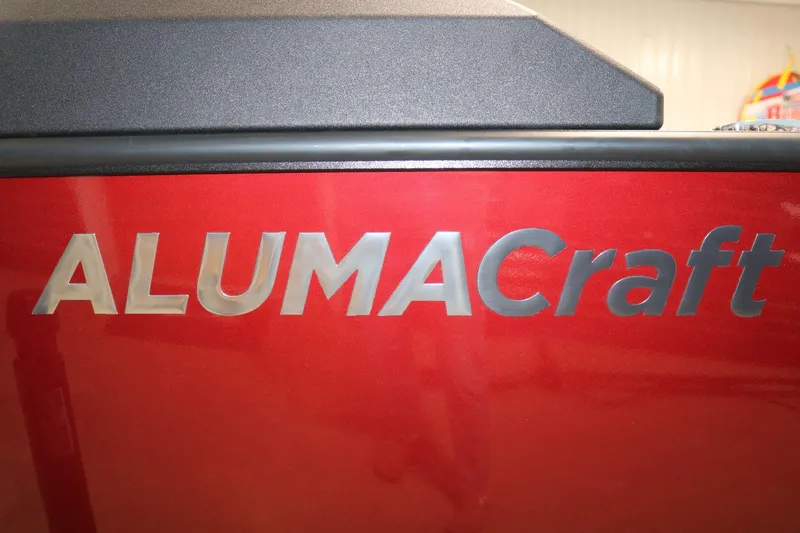 Slide: The Image of 2025 Alumacraft Competitor 175X Sport Rotax S, red exterior with logo detail. - 23