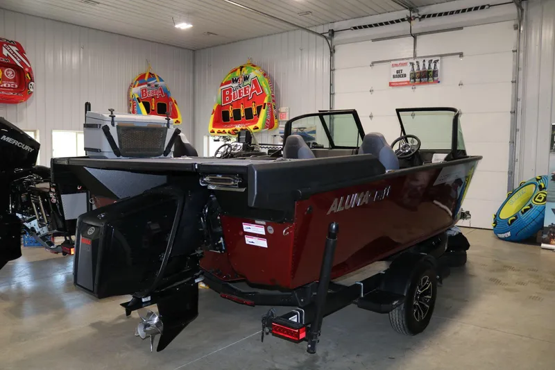 Slide: The Image of 2025 Alumacraft Competitor 175X Sport Rotax S boat in showroom, rear view. - 3