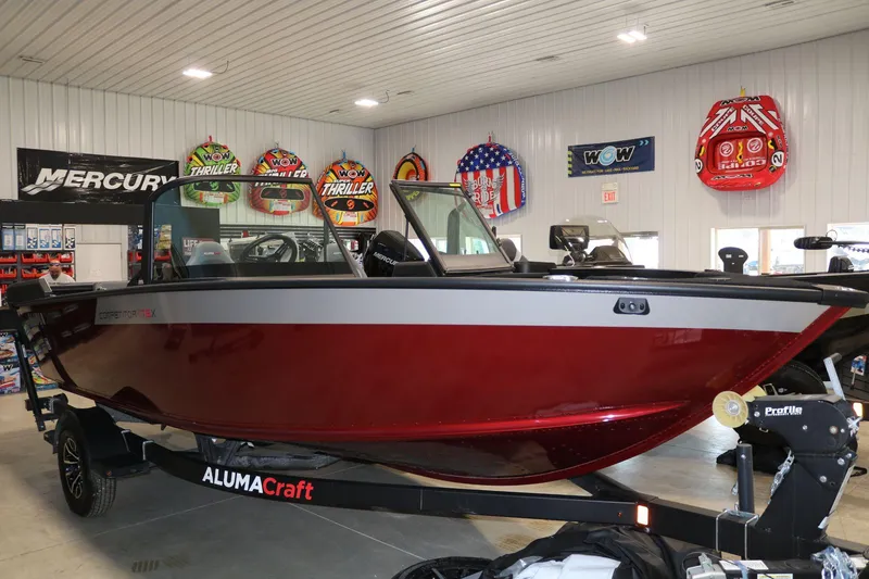 Slide: The Image of 2025 Alumacraft Competitor 175X Sport Rotax S boat in showroom, red and silver design. - 4