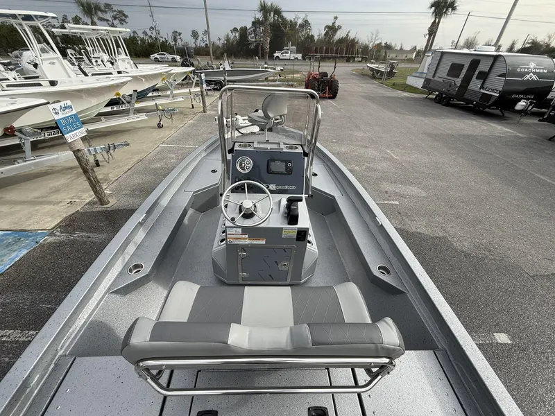 Slide: The Image of 2025 Xpress Hyper-Lift Series H20B boat with new console, parked in dealership lot. - 10