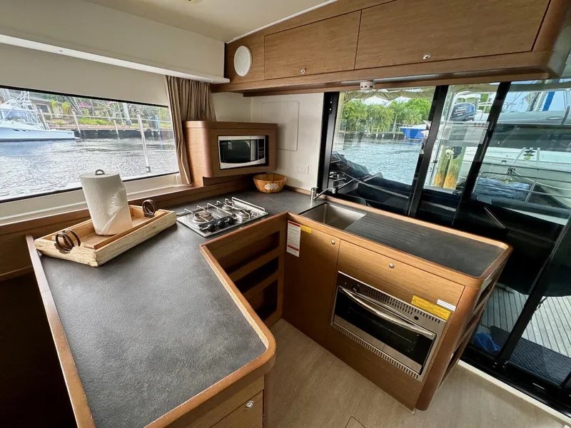 Slide: The Image of Modern kitchen interior of 2019 Lagoon 42 catamaran with appliances and waterfront view. - 22