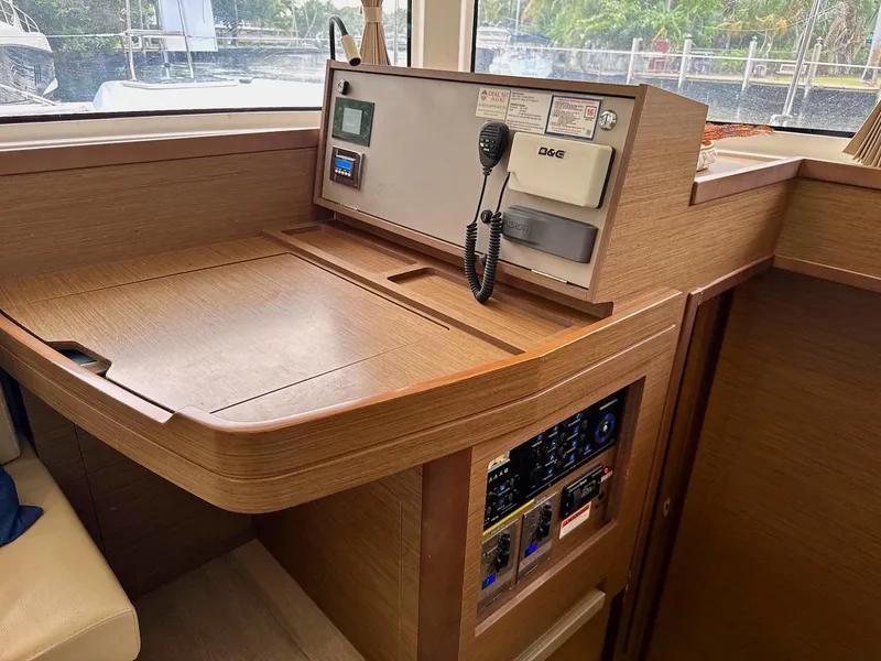 Slide: The Image of 2019 Lagoon 42 yacht navigation station with control panel and communication equipment. - 23