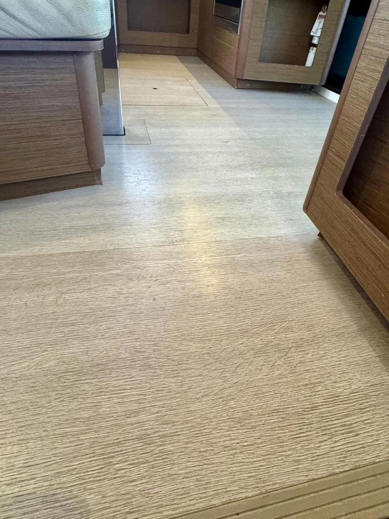 Slide: The Image of Interior view of 2019 Lagoon 42 yacht with wooden flooring and cabinetry. - 44