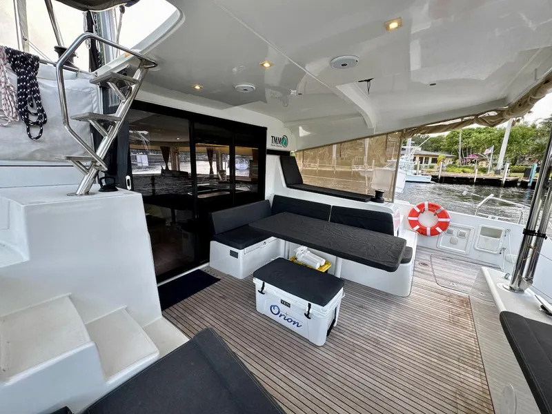 Slide: The Image of Spacious deck of 2019 Lagoon 42 catamaran with seating and safety equipment. - 5