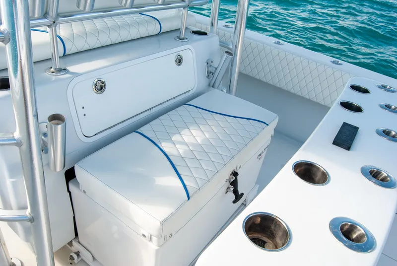 Slide: The Image of 2019 Contender 39 ST boat interior with cushioned seating and rod holders. - 11