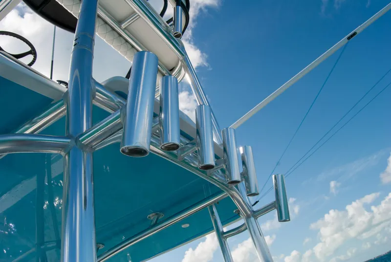 Slide: The Image of 2019 Contender 39 ST boat with stainless steel rod holders against a blue sky. - 14