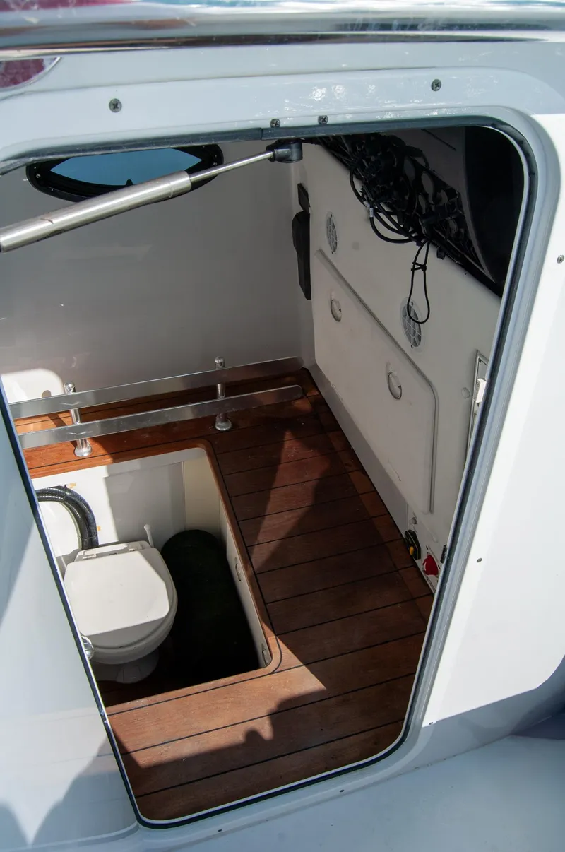 Slide: The Image of 2019 Contender 39 ST boat interior with wooden flooring and compact toilet. - 15