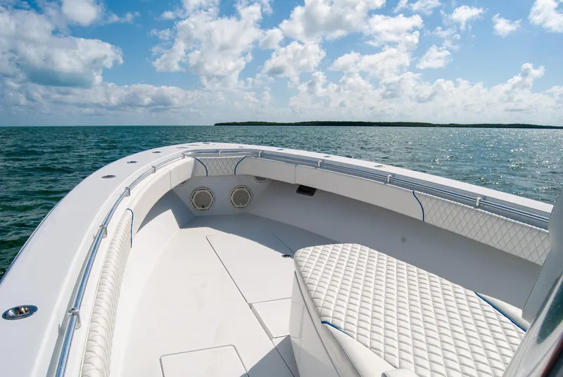Slide: The Image of 2019 Contender 39 ST boat on open water, featuring spacious seating and clear skies. - 17