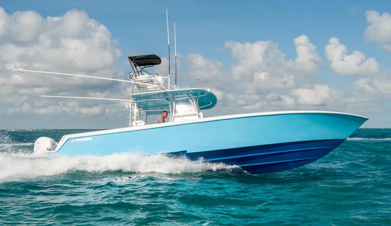 Slide: The Image of 2019 Contender 39 ST boat cruising on ocean with blue sky background. - 2
