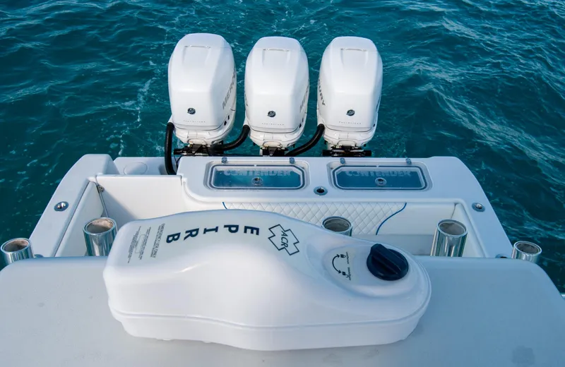 Slide: The Image of 2019 Contender 39 ST boat with triple outboard engines on blue water. - 23