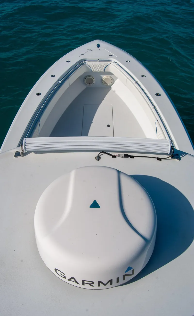 Slide: The Image of 2019 Contender 39 ST boat with Garmin equipment on deck, floating on clear blue water. - 24