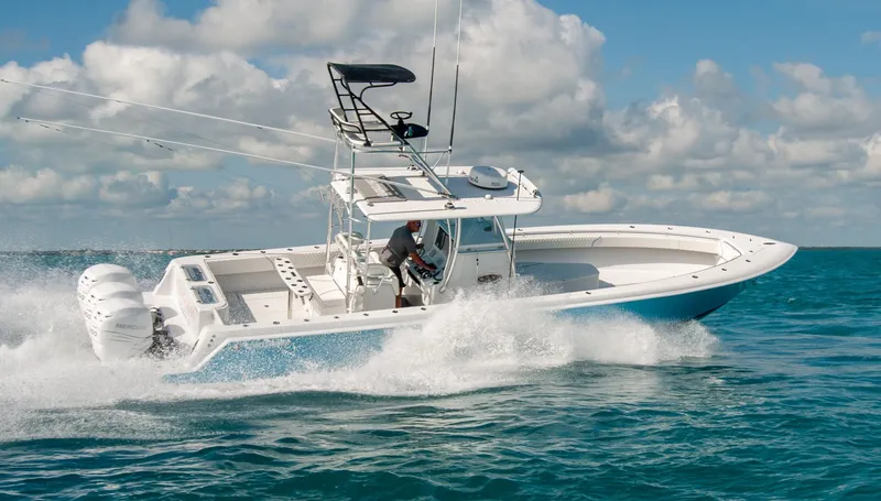 Slide: The Image of 2019 Contender 39 ST boat cruising on open water under a cloudy sky. - 26