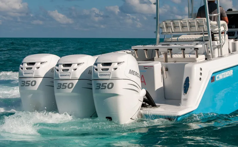 Slide: The Image of 2019 Contender 39 ST boat with triple Mercury 350 engines on the ocean. - 27