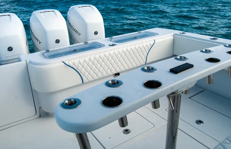 Slide: The Image of 2019 Contender 39 ST boat with multiple rod holders and Mercury engines on the ocean. - 28