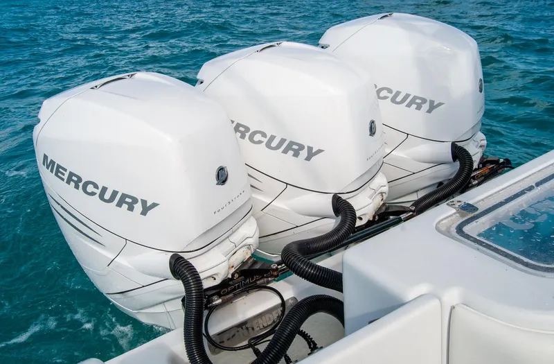 Slide: The Image of Triple Mercury outboard engines on 2019 Contender 39 ST boat in blue ocean. - 3