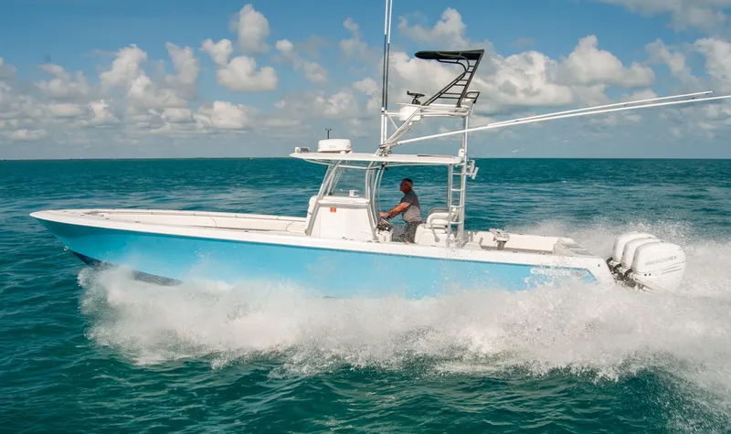 Slide: The Image of 2019 Contender 39 ST boat cruising on open water under a clear sky. - 31