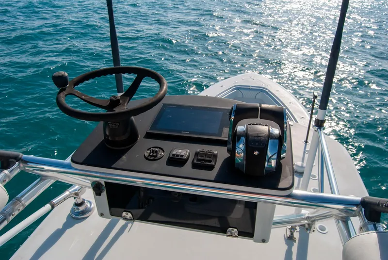 Slide: The Image of 2019 Contender 39 ST boat helm with steering wheel and controls on open water. - 7