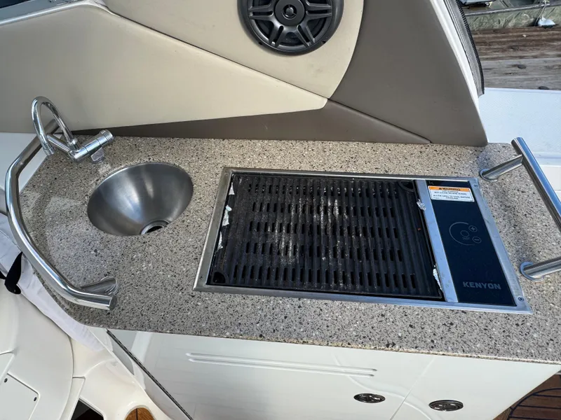 Slide: The Image of Outdoor kitchenette on 2016 Sea Ray 370 Sundancer with sink and grill. - 11