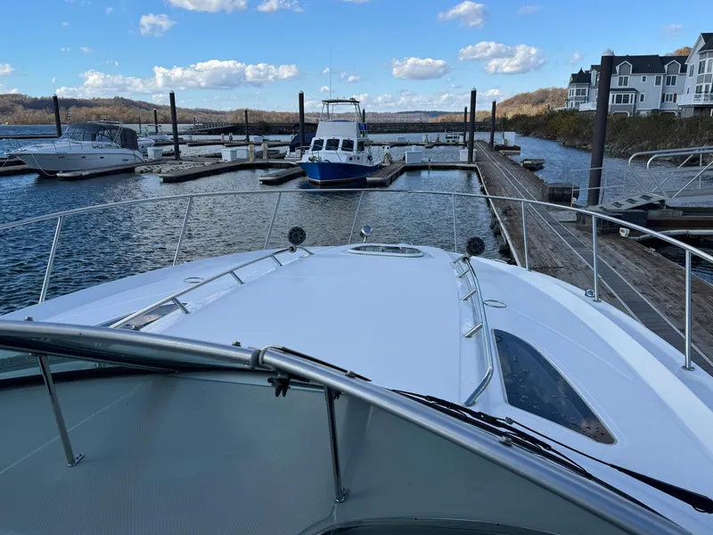 Slide: The Image of 2016 Sea Ray 370 Sundancer docked at marina with scenic waterfront view. - 18