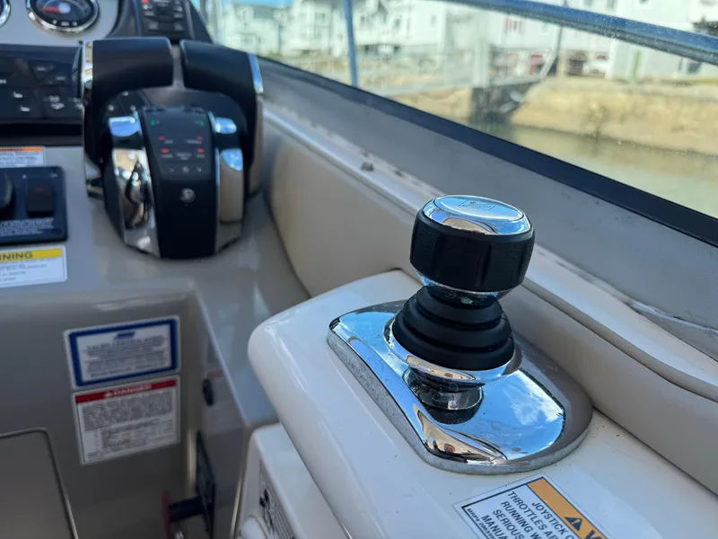 Slide: The Image of Control panel of 2016 Sea Ray 370 Sundancer boat with joystick and throttle. - 21
