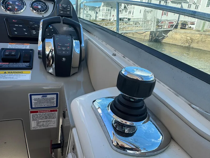 Slide: The Image of Control panel of a 2016 Sea Ray 370 Sundancer boat with joystick and throttle. - 22