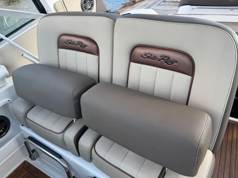 Slide: The Image of 2016 Sea Ray 370 Sundancer boat seats with branded upholstery and armrests. - 23