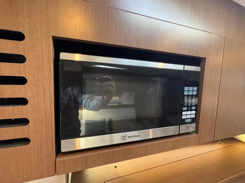 Slide: The Image of Built-in microwave in 2016 Sea Ray 370 Sundancer yacht kitchen. - 30