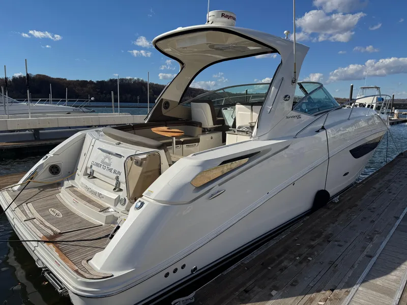 Slide: The Image of 2016 Sea Ray 370 Sundancer yacht docked under clear skies. - 4