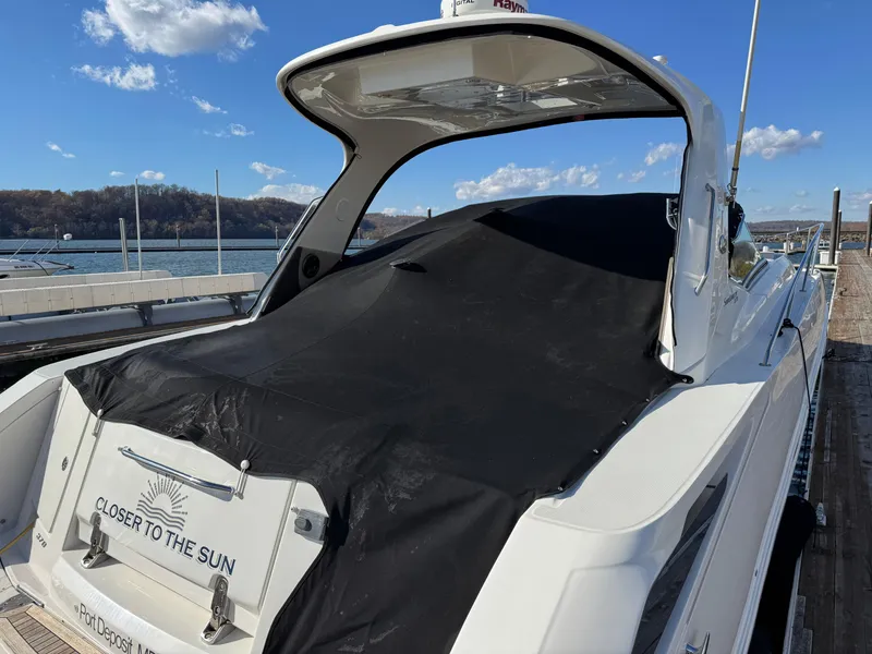 Slide: The Image of 2016 Sea Ray 370 Sundancer yacht docked, covered, with "Closer to the Sun" text. - 5