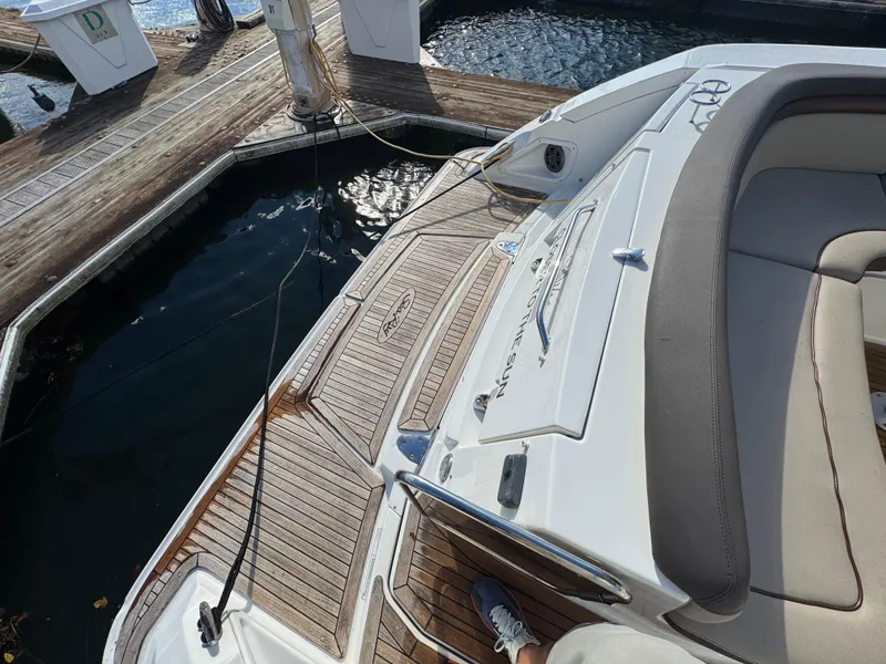 Slide: The Image of 2016 Sea Ray 370 Sundancer docked, featuring teak deck and comfortable seating. - 8