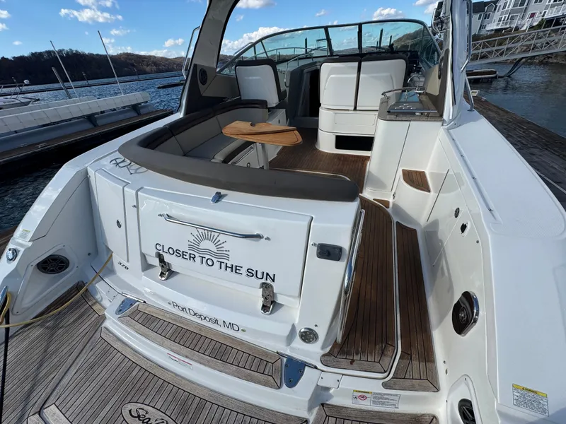 Slide: The Image of 2016 Sea Ray 370 Sundancer yacht with spacious deck and seating, docked at a marina. - 9