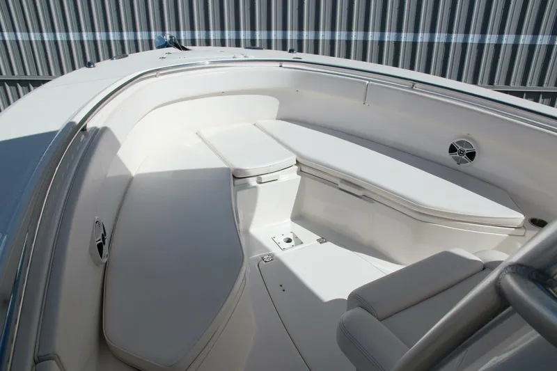 Slide: The Image of 2013 Robalo R300 Center Console boat interior with white seating and storage compartments. - 12