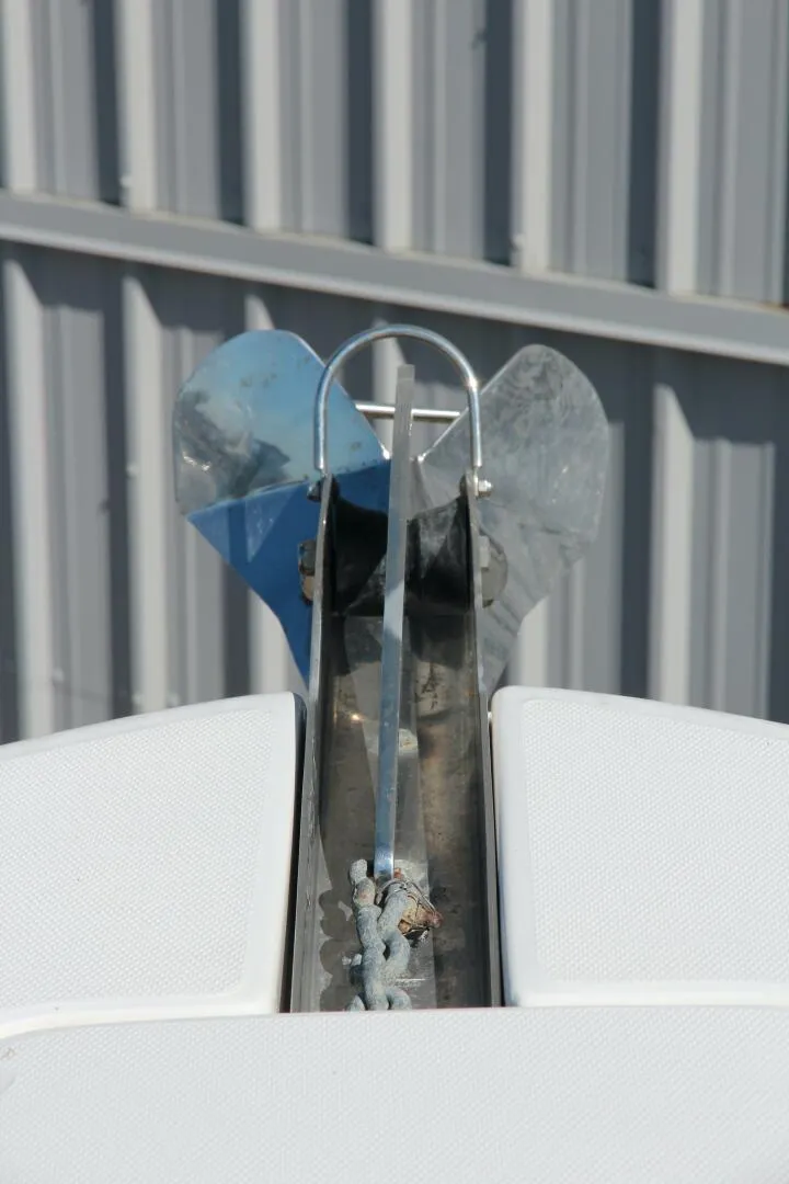 Slide: The Image of Anchor on 2013 Robalo R300 Center Console boat, docked near metal siding. - 13