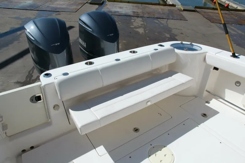 Slide: The Image of 2013 Robalo R300 Center Console boat with dual Yamaha engines, featuring a spacious deck. - 17