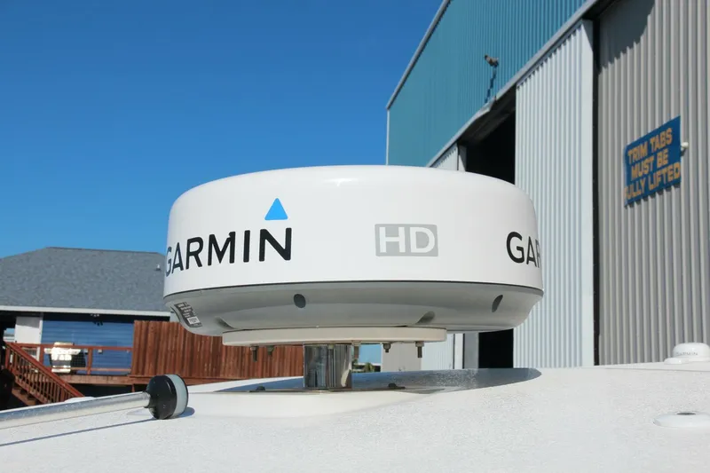 Slide: The Image of Garmin HD radar on 2013 Robalo R300 Center Console boat near a marina. - 18