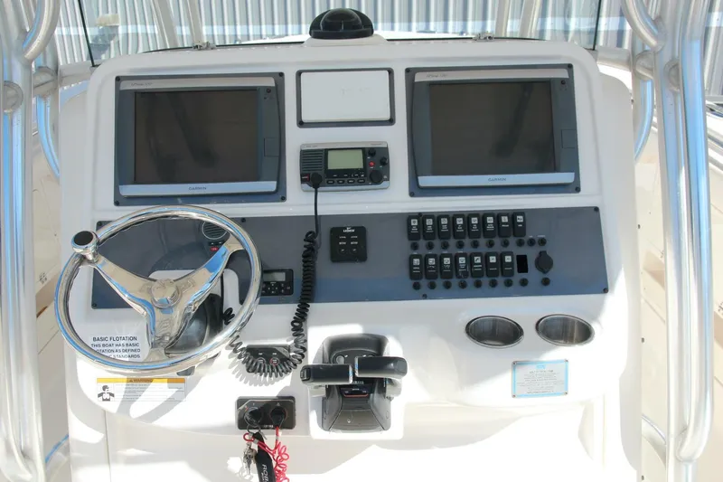 Slide: The Image of 2013 Robalo R300 Center Console dashboard with dual screens and controls. - 2