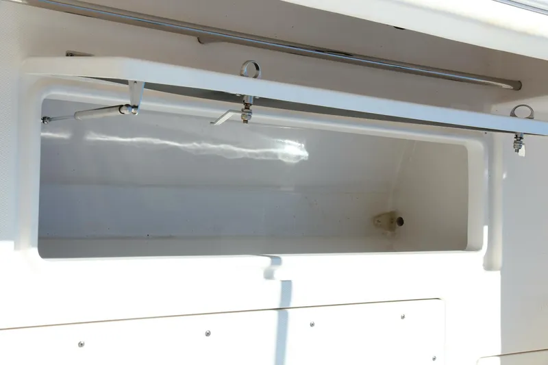 Slide: The Image of 2013 Robalo R300 Center Console storage compartment, open and empty. - 21