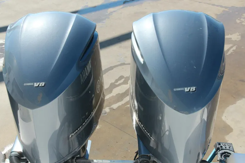 Slide: The Image of Twin Yamaha V8 outboard engines on a 2013 Robalo R300 Center Console boat. - 25