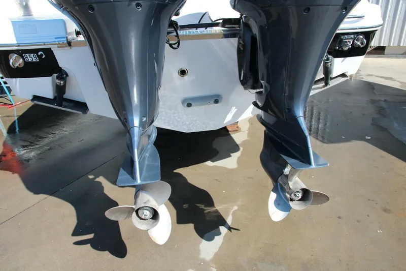 Slide: The Image of Twin outboard motors on a 2013 Robalo R300 Center Console boat. - 27